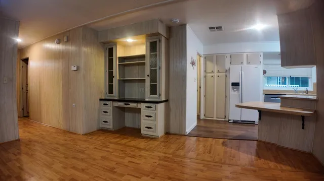 a view of a kitchen with furniture and a wooden floor
