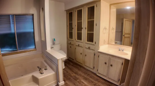 a bathroom with a sink a toilet and shower