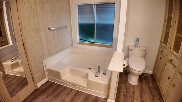 a white toilet sitting next to a bathroom sink