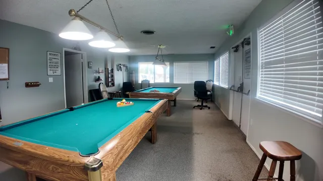 a room with pool table table and chairs
