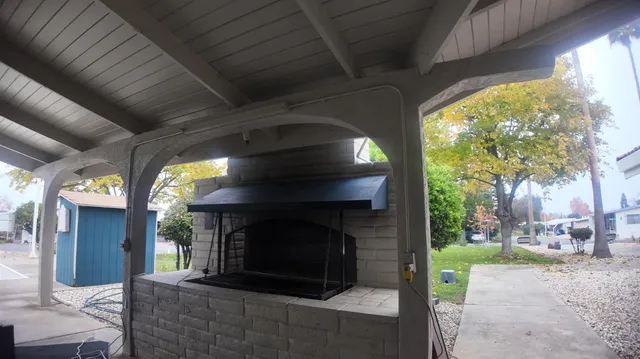 a living room with fireplace and a floor to ceiling window