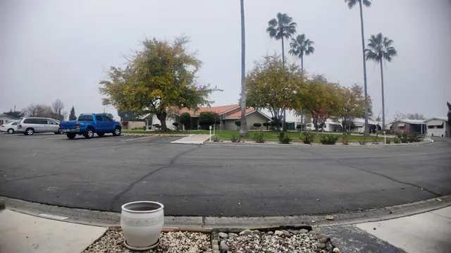 a city street with cars parked on the roadside