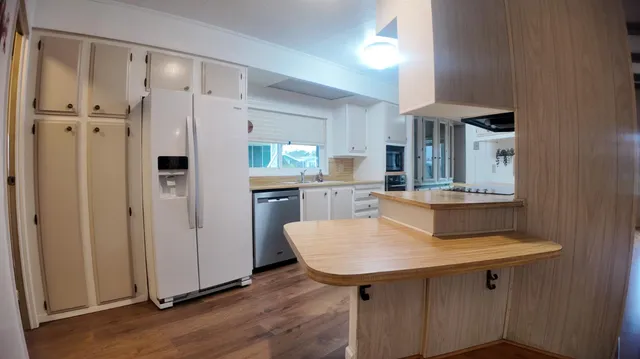 a kitchen with a table and chairs