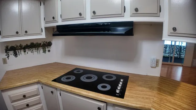 a view of kitchen with microwave and cabinets