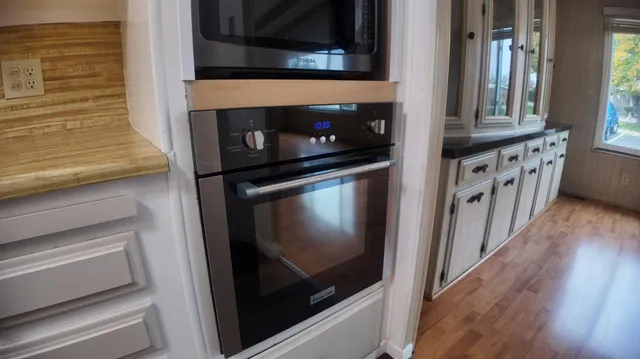 a kitchen with windows and an oven