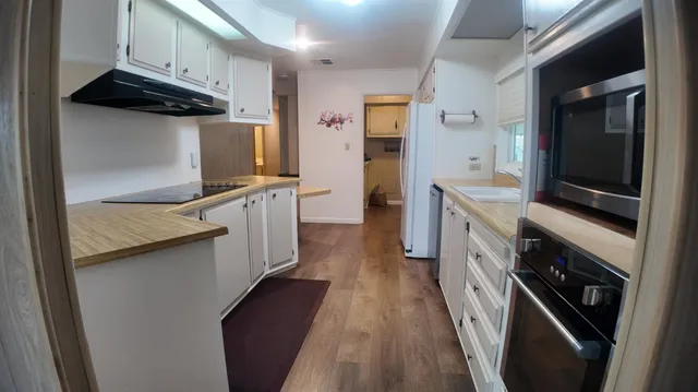 a kitchen with stainless steel appliances a stove microwave and a refrigerator