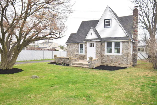 a view of a house with a yard and sitting area