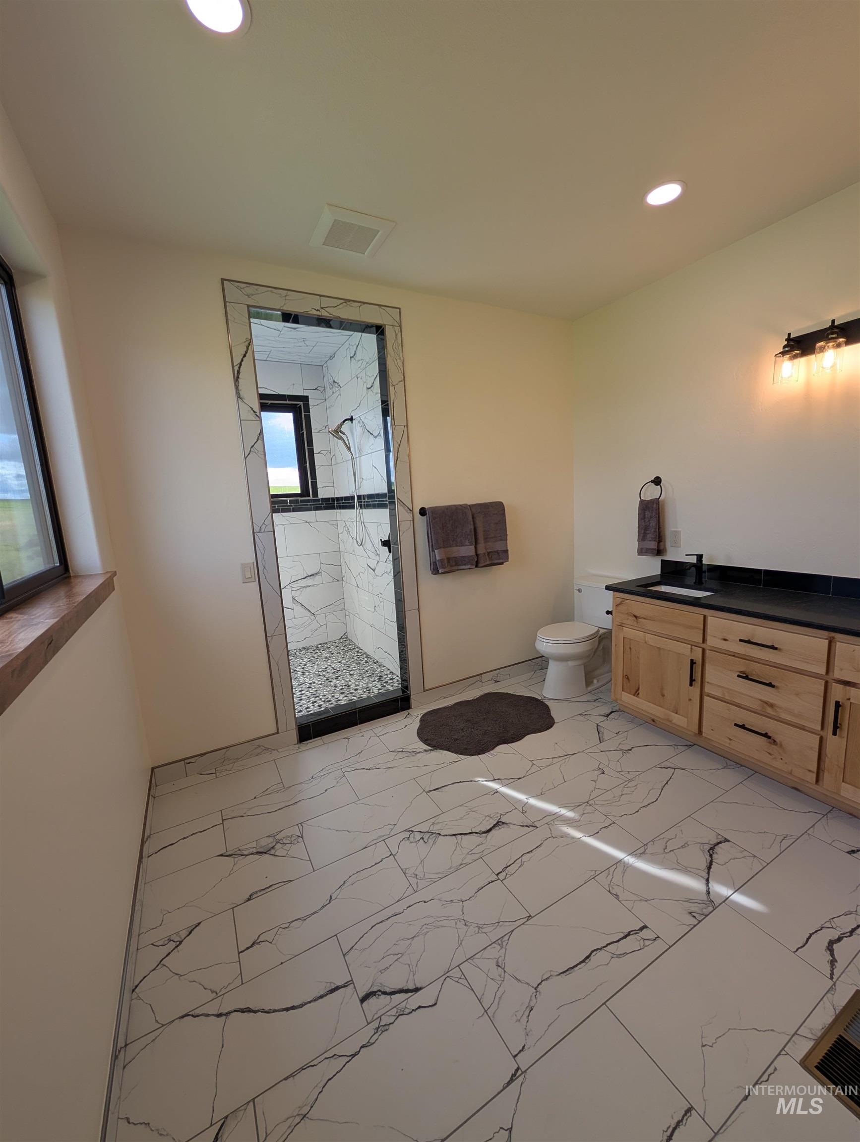 137 Angus Ranch Grangeville, ID 83530 - Photo 15 of 49 Bathroom featuring vanity, light marble finish flooring, a marble finish shower, and recessed lighting