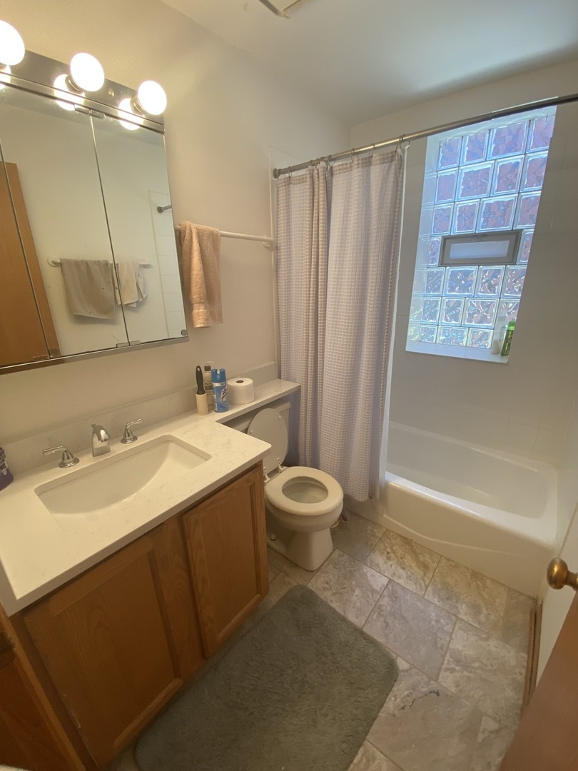 632 West Patterson Avenue, Unit 1N Chicago, IL 60613 - Photo 12 of 17 a bathroom with a sink toilet and shower