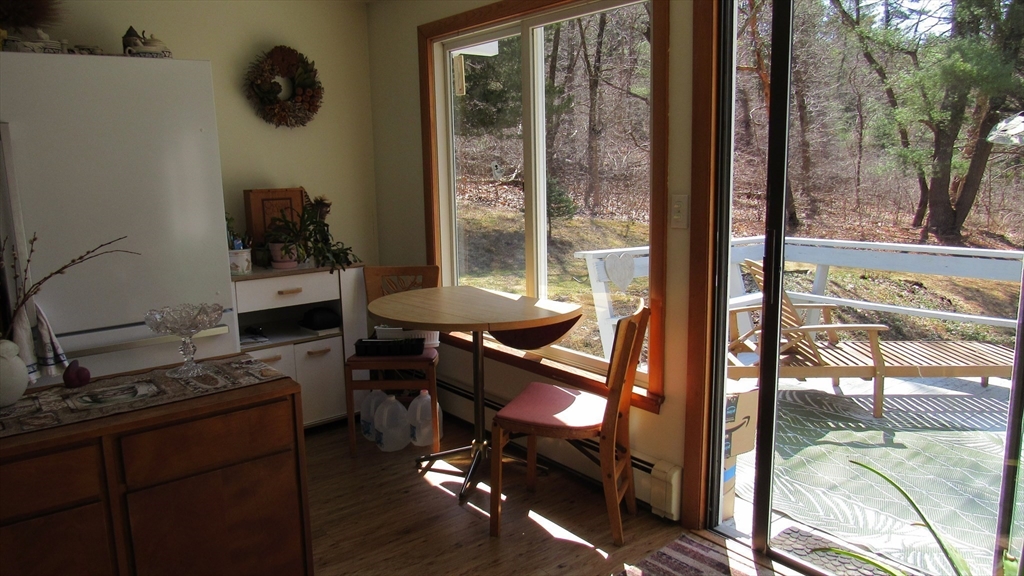 288 Linebrook Road Ipswich, MA 01938 - Photo 18 of 26 a living room with furniture and a floor to ceiling window