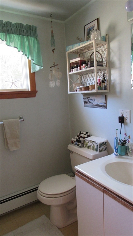 288 Linebrook Road Ipswich, MA 01938 - Photo 21 of 26 a bathroom with a sink a toilet and a window
