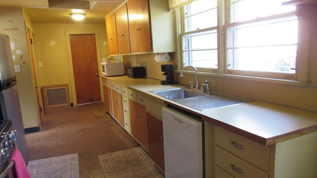 288 Linebrook Road Ipswich, MA 01938 - Photo 6 of 26 a kitchen with stainless steel appliances a sink a counter space and a window