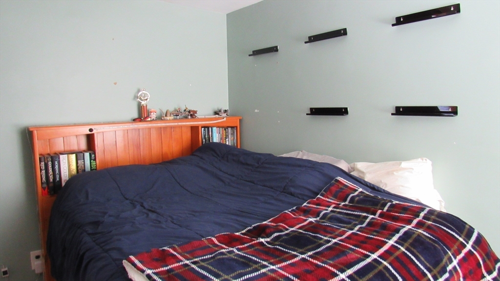 288 Linebrook Road Ipswich, MA 01938 - Photo 8 of 26 a bedroom with a bed and wooden floor