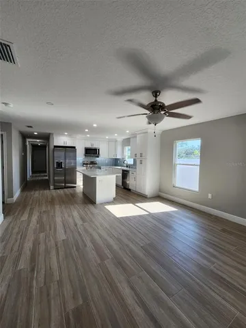a view of a kitchen with a sink and a stove top oven