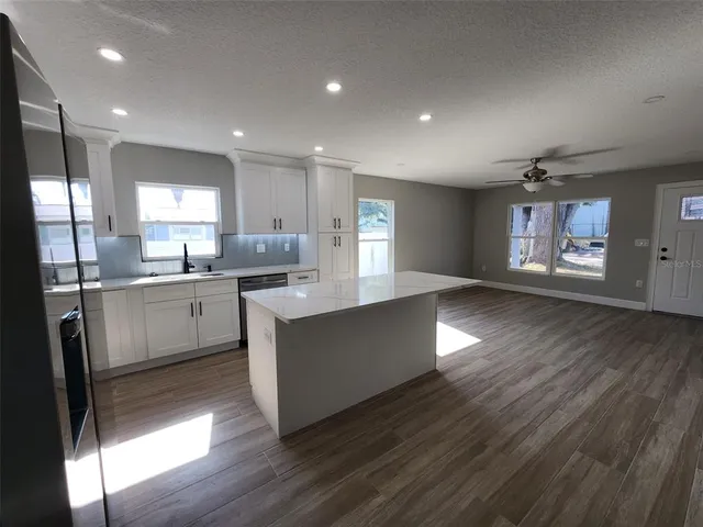 a kitchen with counter top space cabinets and appliances