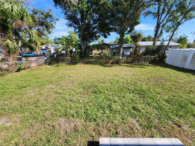 a view of a yard with table and chairs