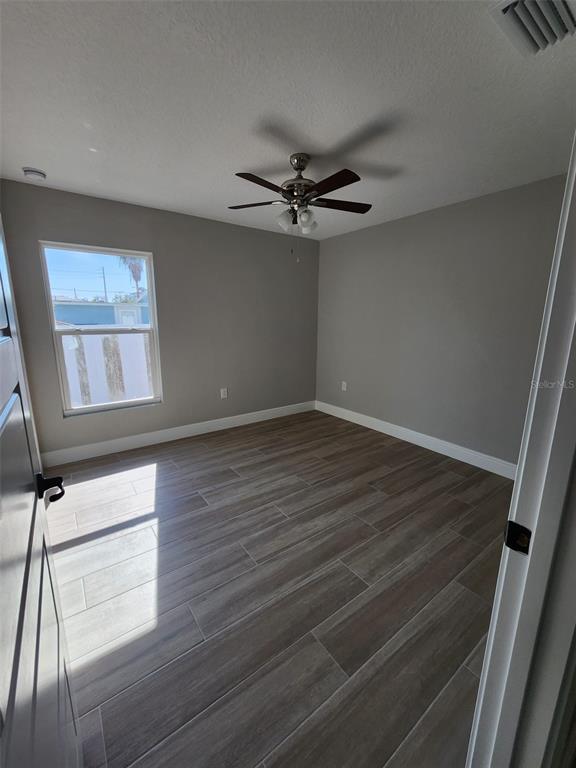 1013 13th Street East Bradenton, FL 34208 - Photo 3 of 14 a view of empty room with wooden floor and fan