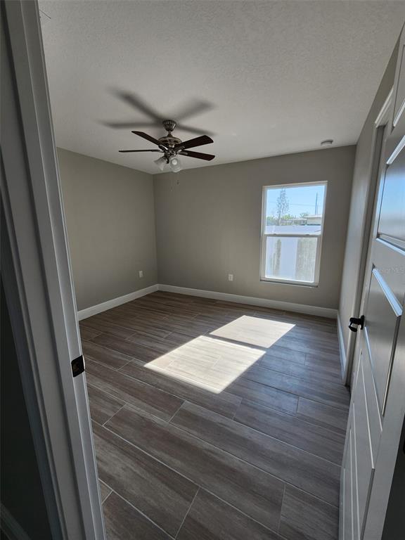 1013 13th Street East Bradenton, FL 34208 - Photo 4 of 14 an empty room with wooden floor and windows