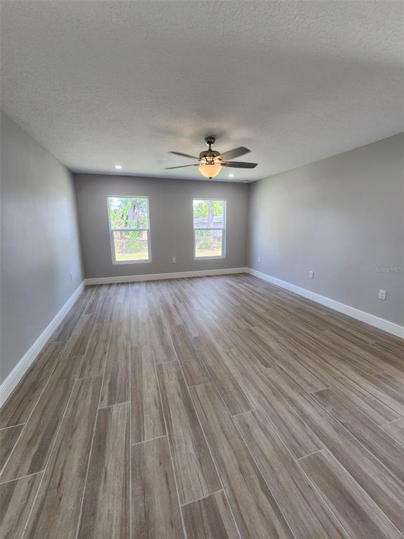1013 13th Street East Bradenton, FL 34208 - Photo 5 of 14 wooden floor in an empty room with a window