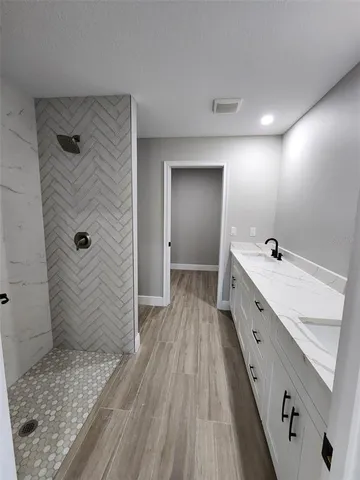 a bathroom with a double vanity sink and mirror