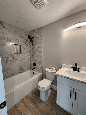 a bathroom with a sink a toilet and a bathtub