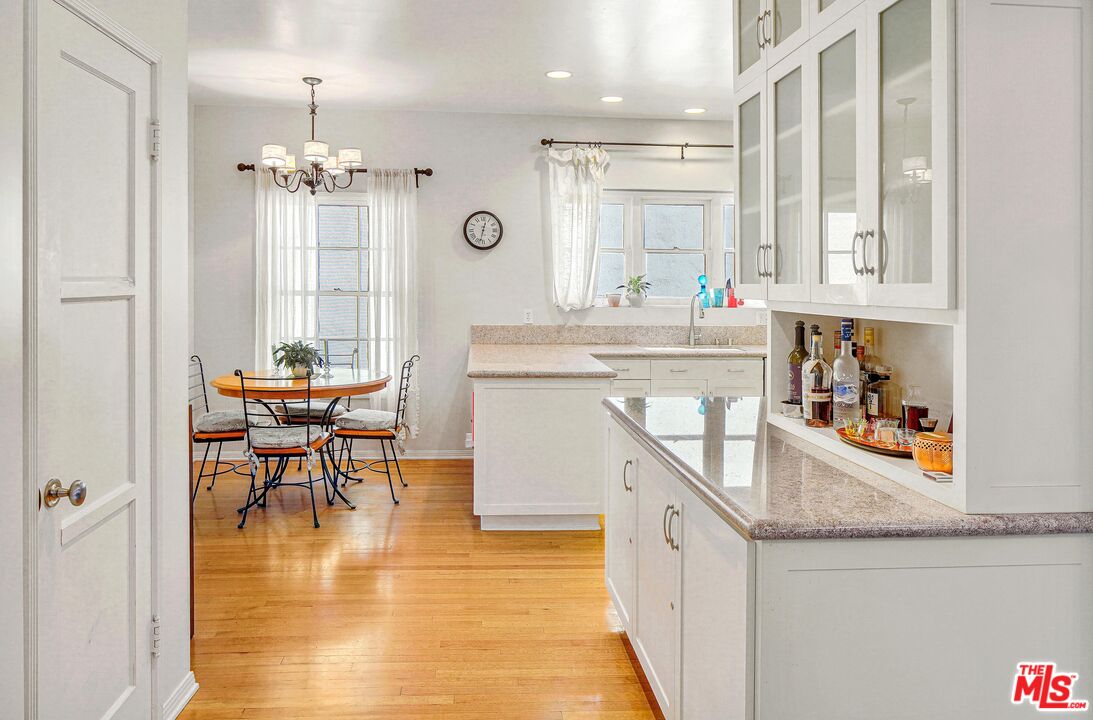 10614 Le Conte Avenue Los Angeles, CA 90024 - Photo 11 of 33 a very nice looking kitchen with granite countertop a stove a sink a dining table and chairs