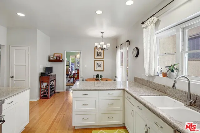 a spacious bathroom with a granite countertop sink double vanity and a mirror