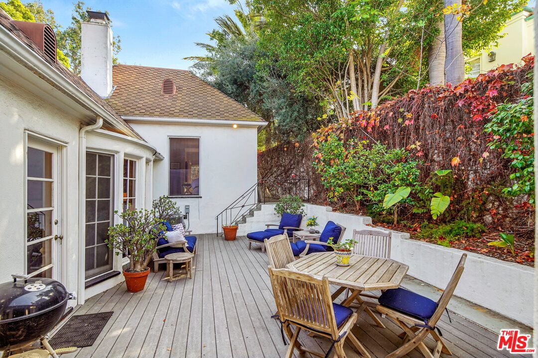 10614 Le Conte Avenue Los Angeles, CA 90024 - Photo 28 of 33 a view of a patio with table and chairs potted plants with wooden floor and fence