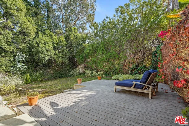a view of a house with backyard sitting area and garden
