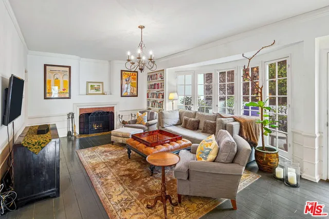 a living room with furniture fireplace and a table