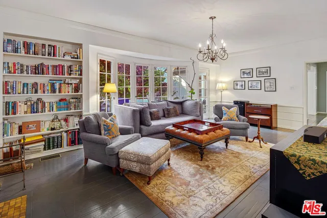 a living room with furniture a bookshelf and a bookshelf