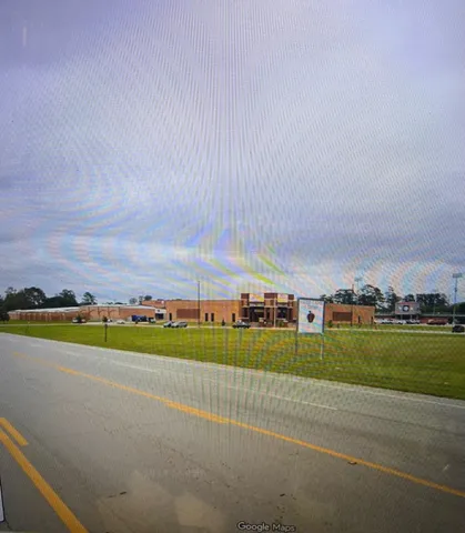 a swimming pool with trees in the background