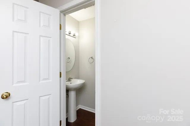 a view of a hallway with entryway door with wooden floor