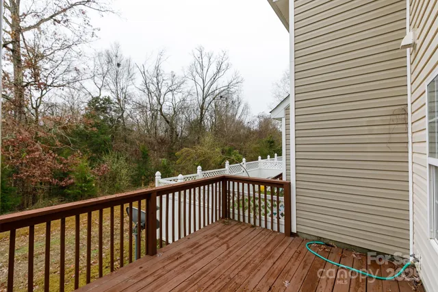 a balcony with wooden floor and fence