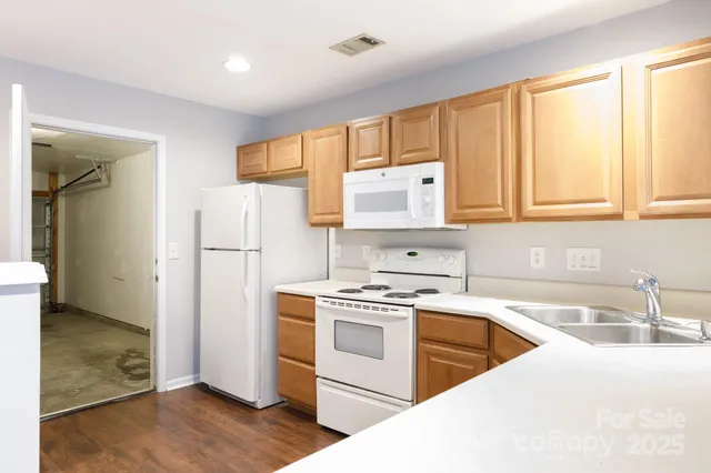 a kitchen with a stove a refrigerator and a sink