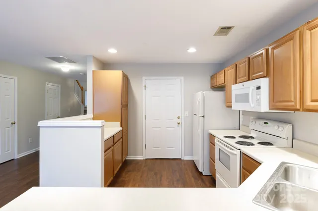 a kitchen with a sink a refrigerator and cabinets
