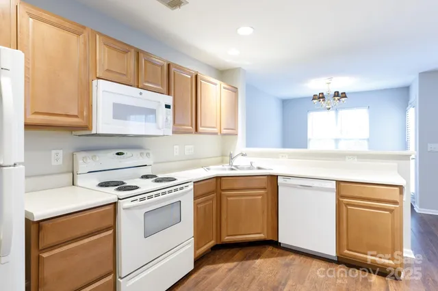 a kitchen with stainless steel appliances granite countertop a sink stove and cabinets