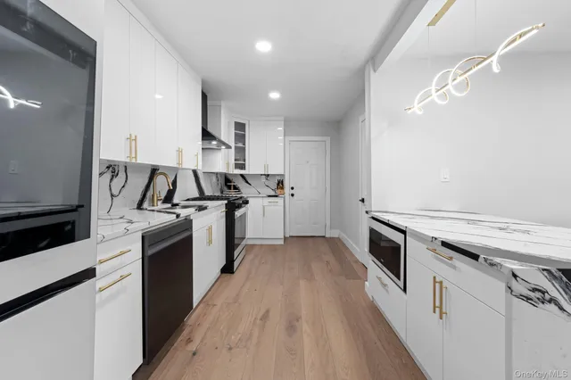 a kitchen with granite countertop a stove and a sink