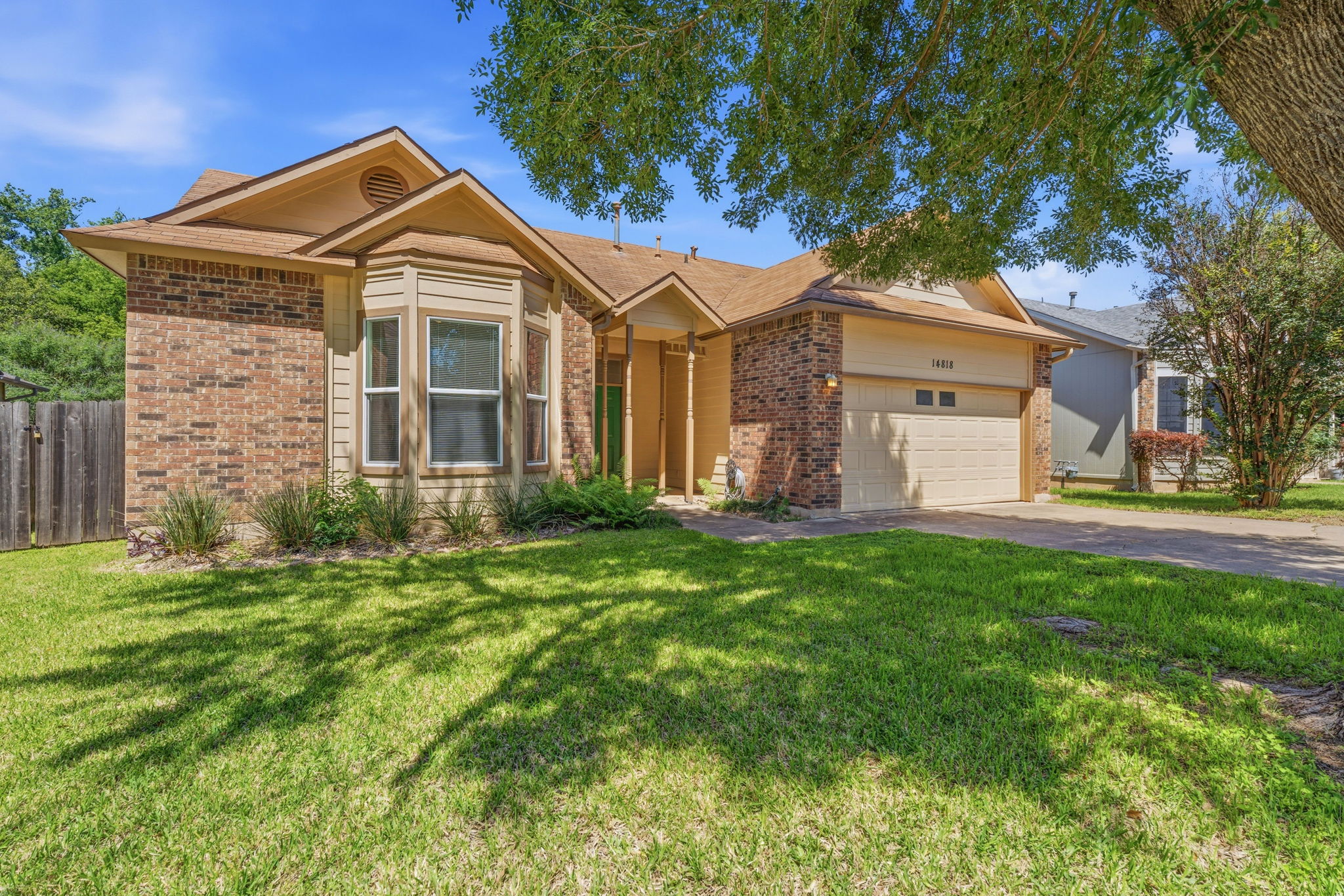 14818 Yellowleaf Trail Austin, TX 78728 - Photo 3 of 26 Traditional brick and siding exterior featuring a prominent bay window, attached garage, and a concrete driveway