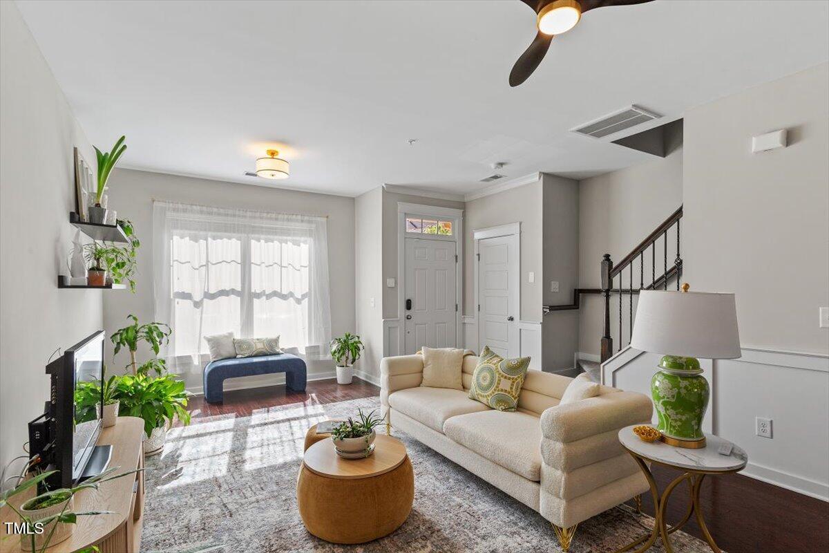7822 Allscott Way Raleigh, NC 27612 - Photo 11 of 33 a living room with furniture potted plant and a window