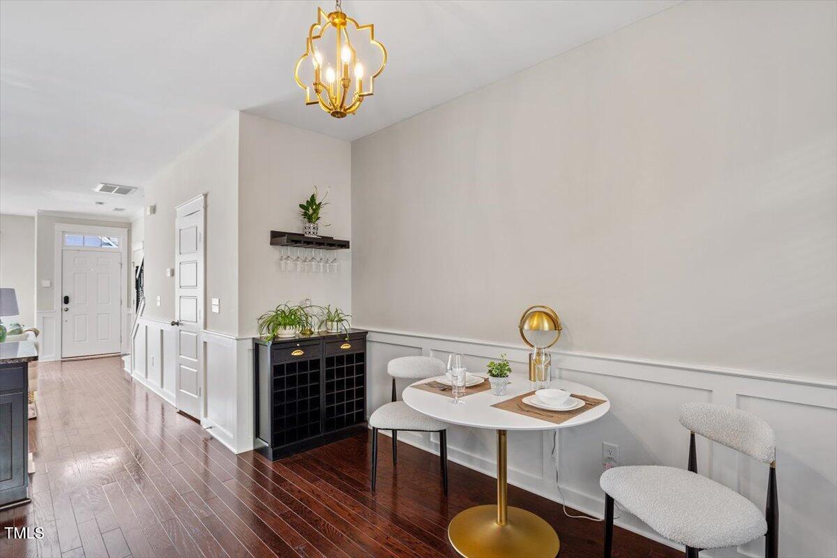 7822 Allscott Way Raleigh, NC 27612 - Photo 17 of 33 a view of a dining room with furniture and wooden floor