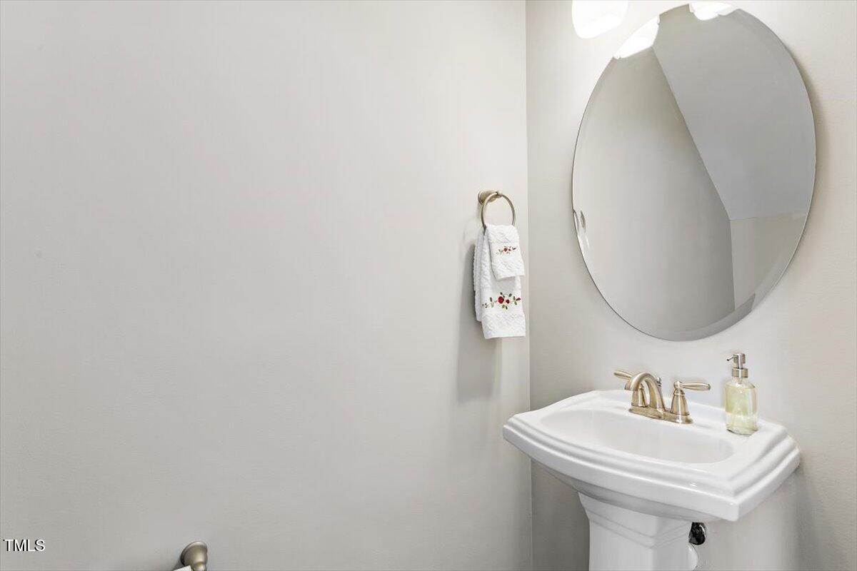 7822 Allscott Way Raleigh, NC 27612 - Photo 19 of 33 a bathroom with a sink and a mirror