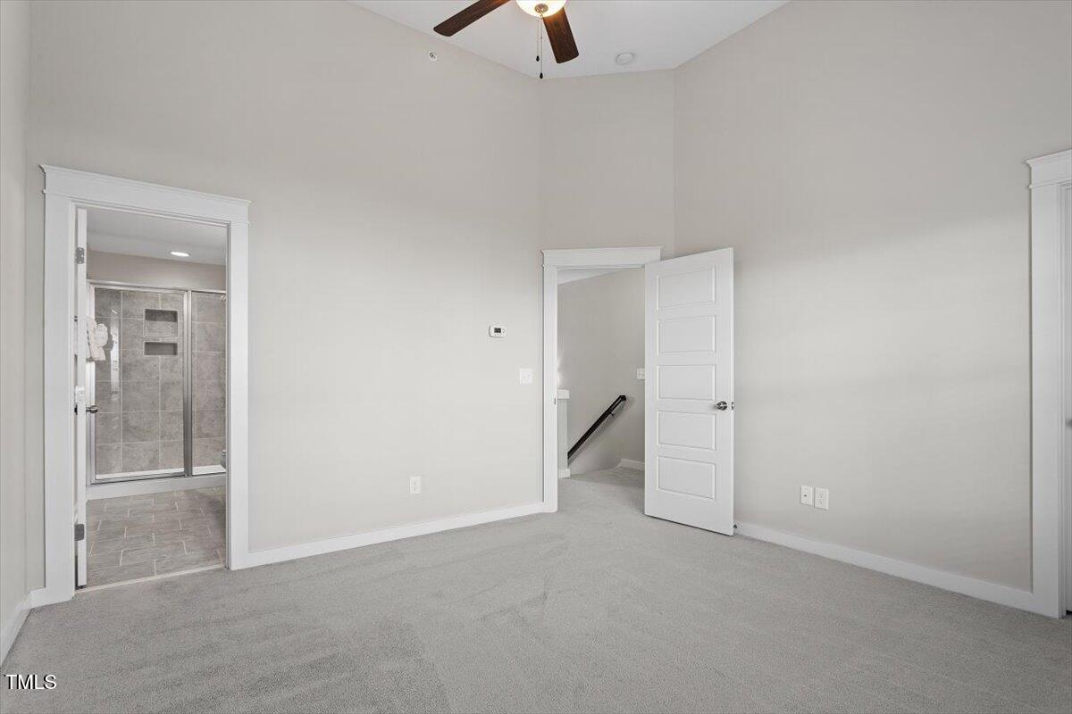 7822 Allscott Way Raleigh, NC 27612 - Photo 21 of 33 an empty room with chandelier fan and windows