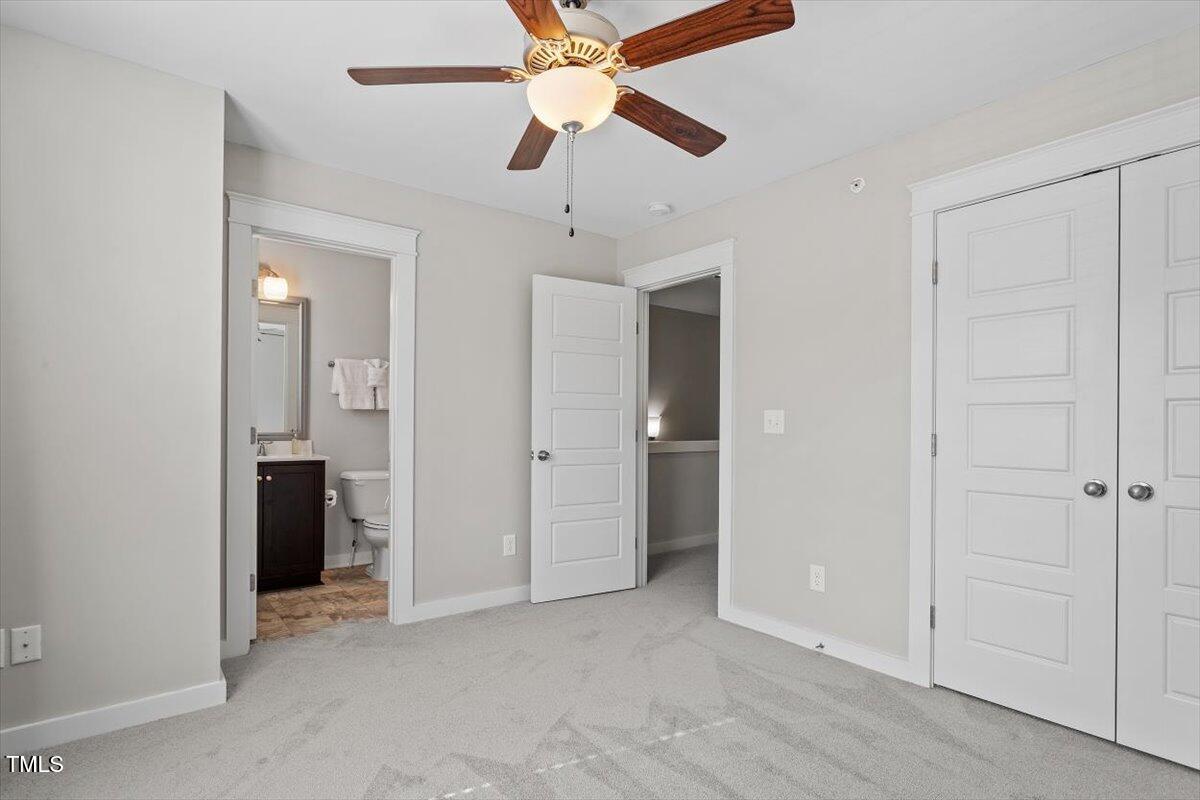 7822 Allscott Way Raleigh, NC 27612 - Photo 24 of 33 an empty room with closet and a ceiling fan