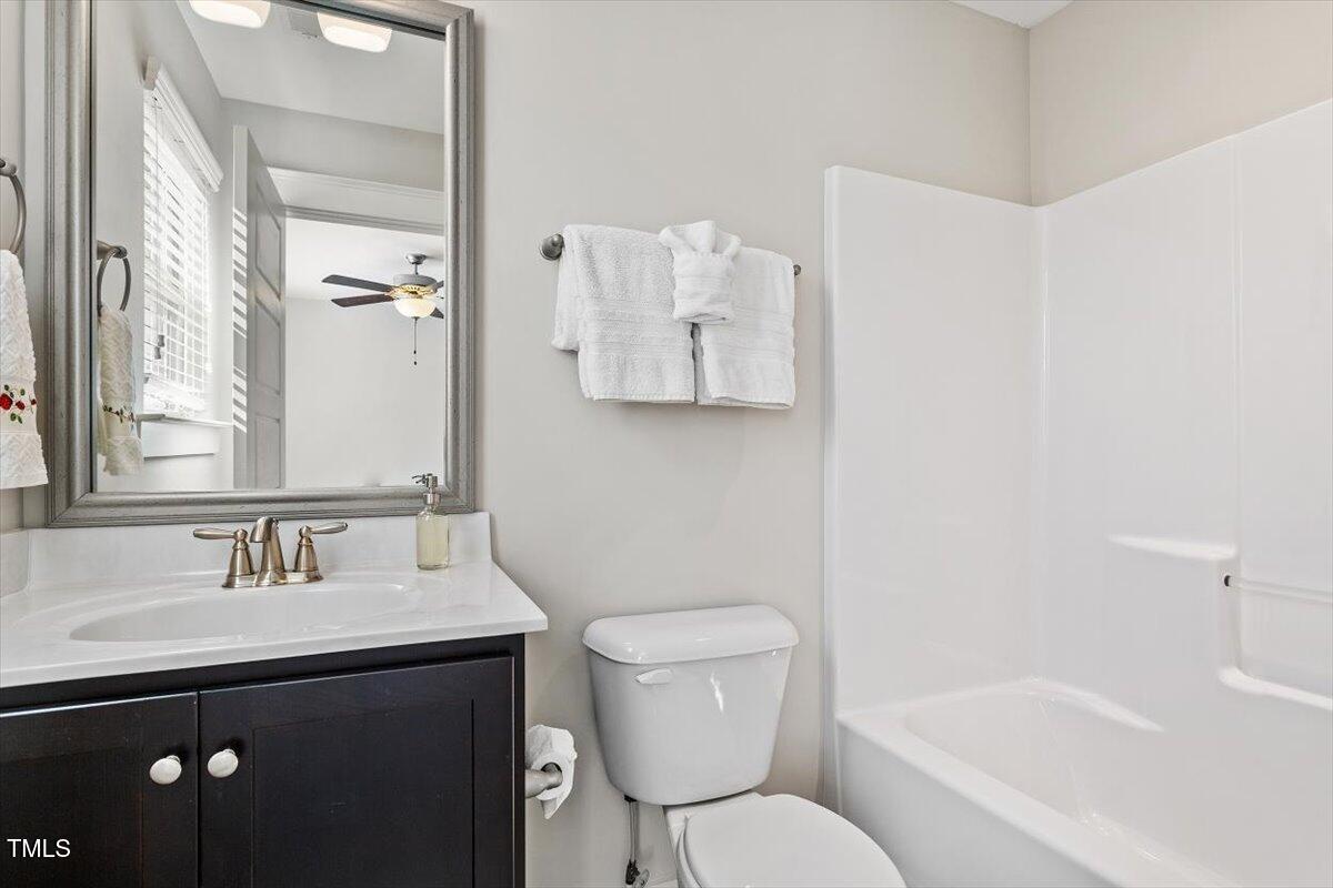 7822 Allscott Way Raleigh, NC 27612 - Photo 27 of 33 a bathroom with a sink toilet and shower