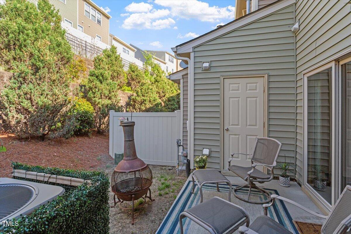 7822 Allscott Way Raleigh, NC 27612 - Photo 28 of 33 a view of a patio with table and chairs and potted plants