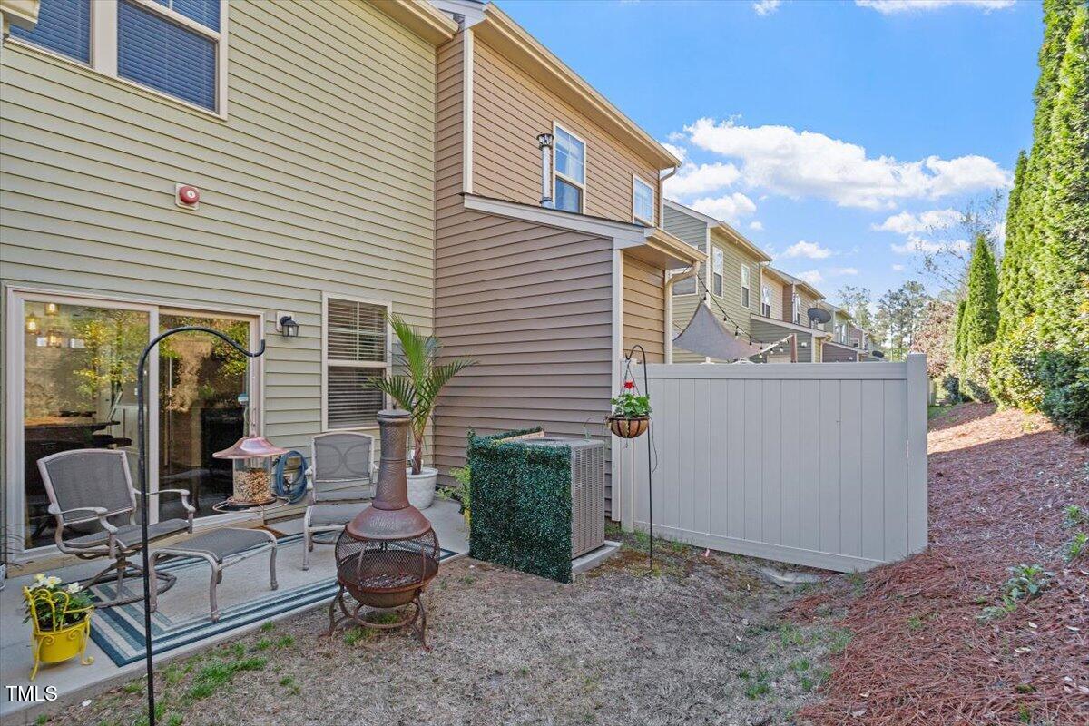 7822 Allscott Way Raleigh, NC 27612 - Photo 29 of 33 a view of backyard with outdoor seating and plants