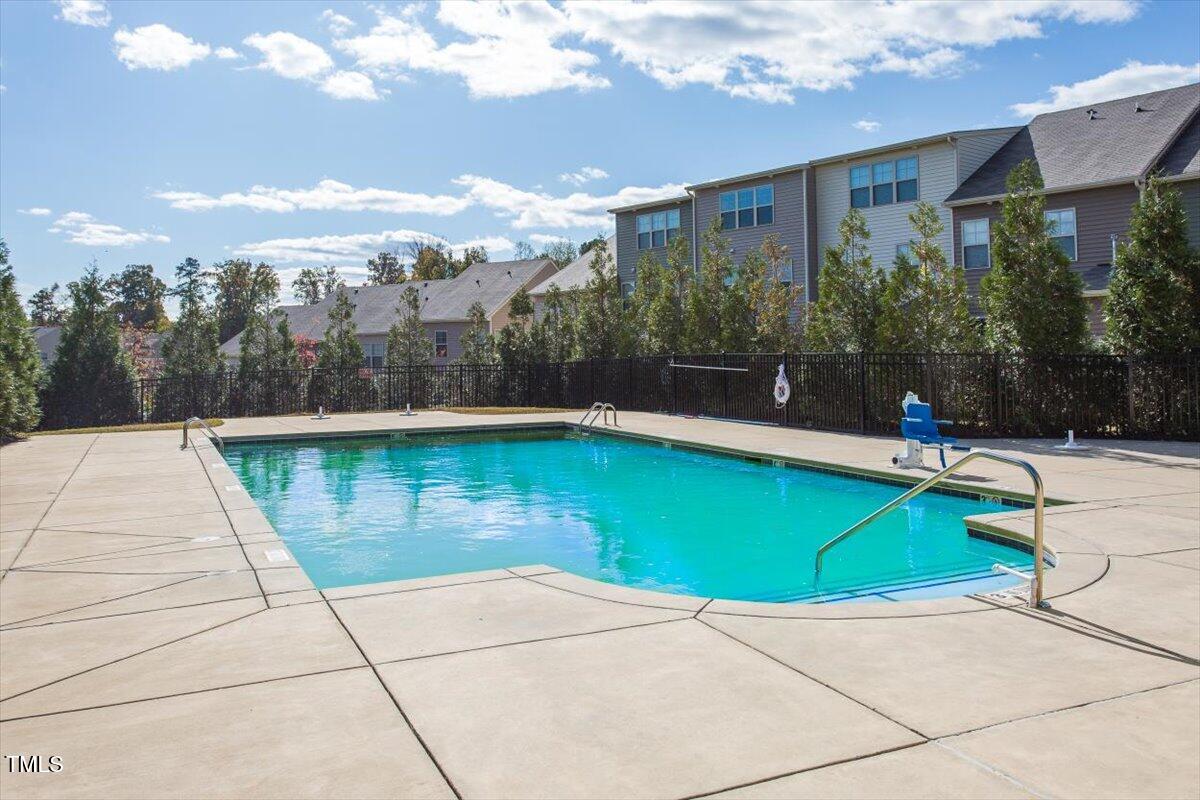 7822 Allscott Way Raleigh, NC 27612 - Photo 30 of 33 a view of a swimming pool with a yard