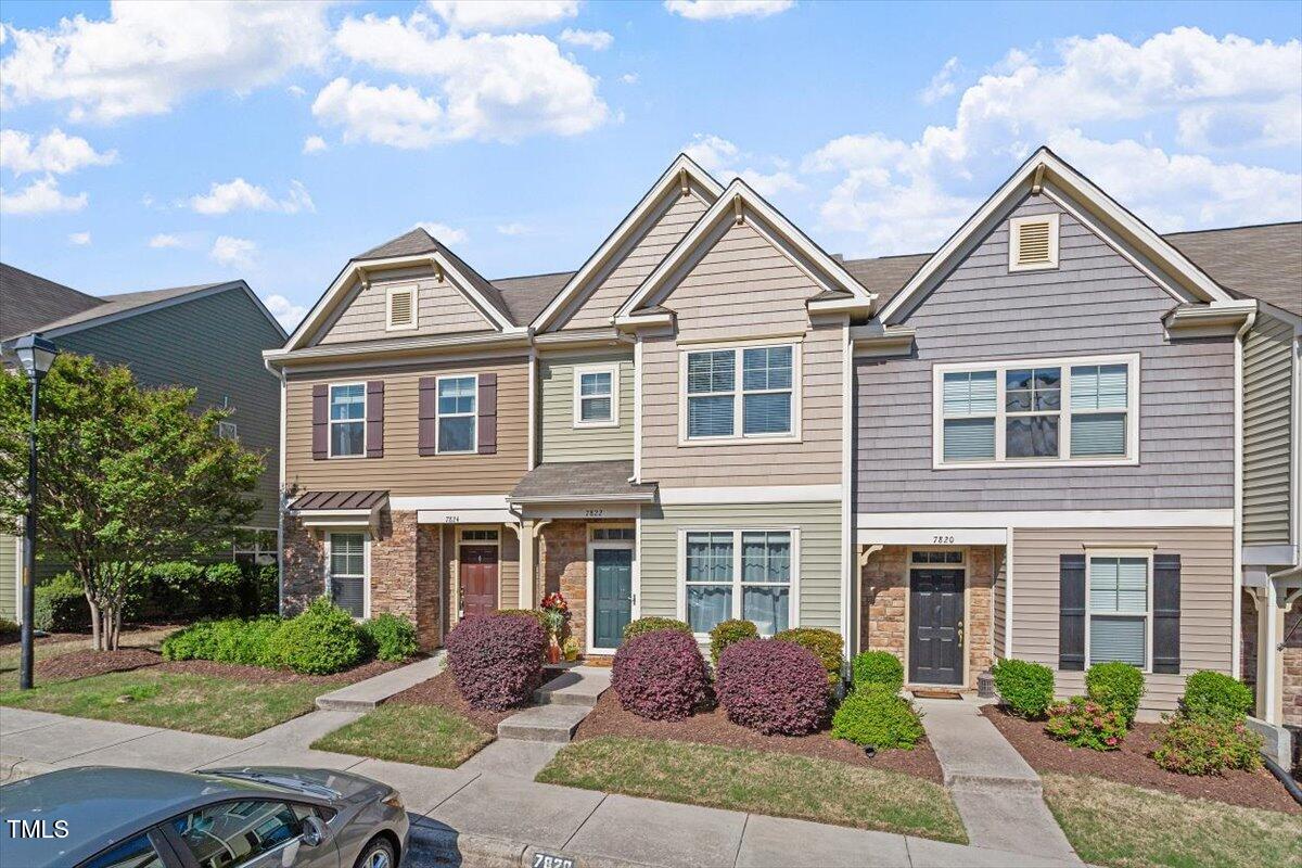 7822 Allscott Way Raleigh, NC 27612 - Photo 4 of 33 a front view of a house with garden