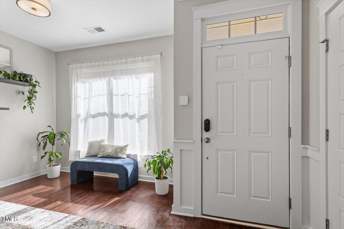 7822 Allscott Way Raleigh, NC 27612 - Photo 6 of 33 a living room with furniture and a potted plant